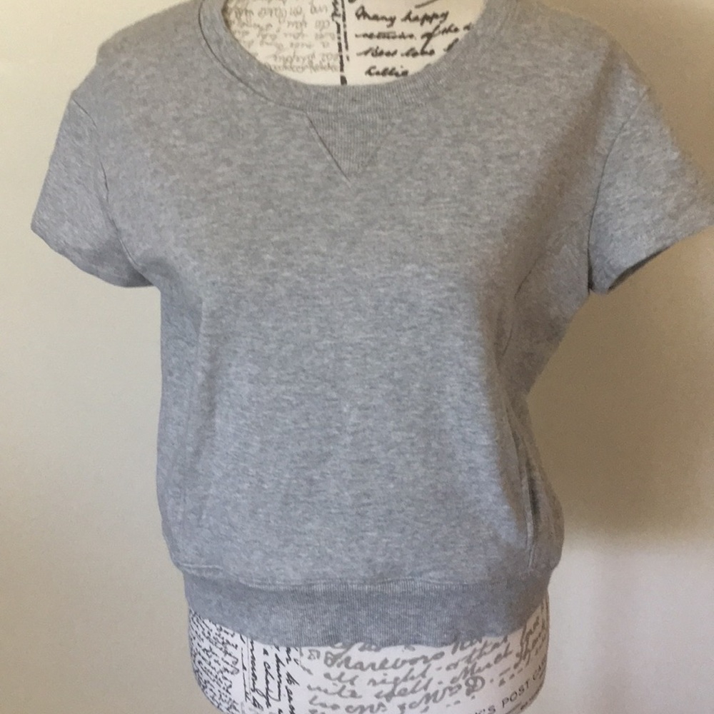 Sweatshirt gray with side pockets. NWOT